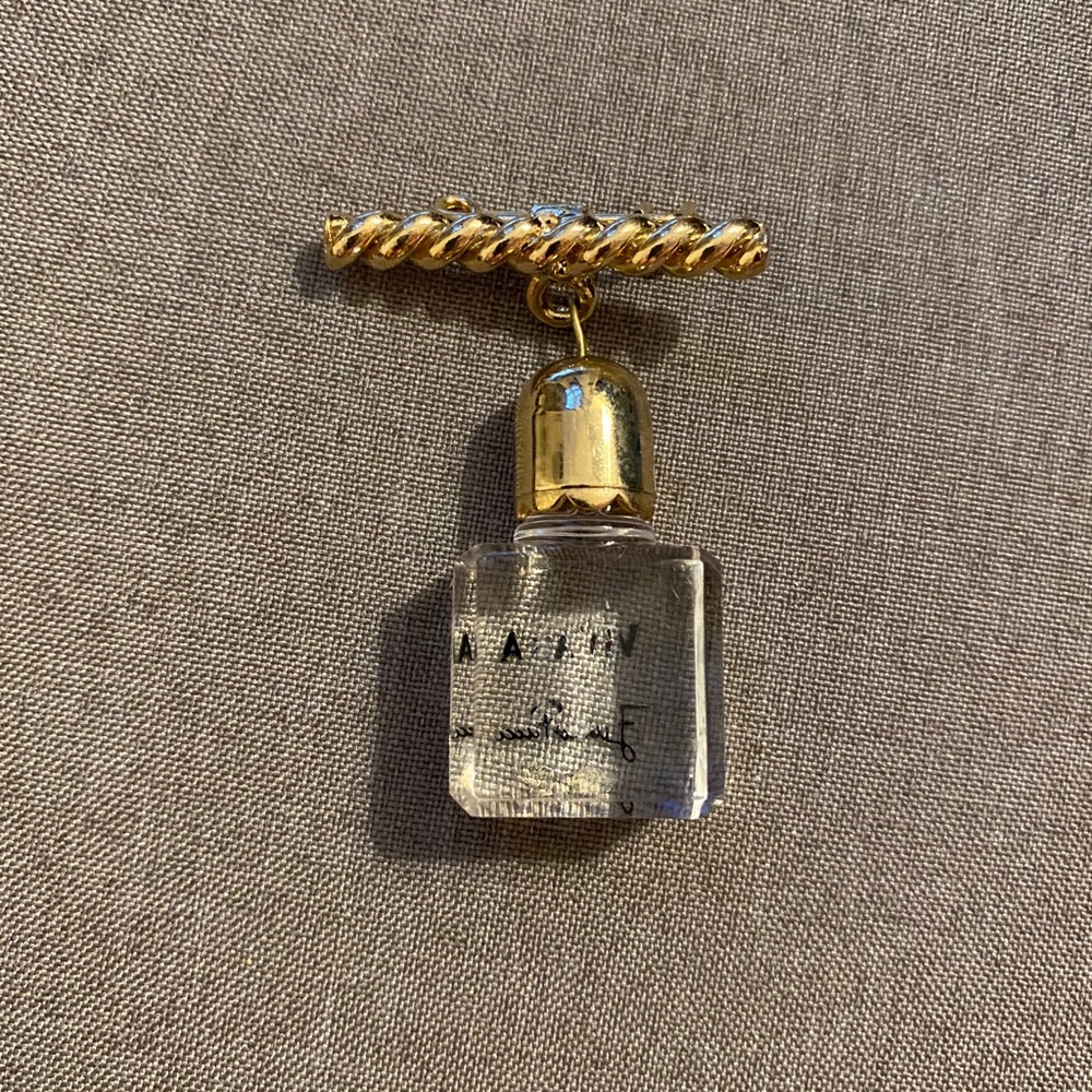 Vintage brass pin with lucite bottle